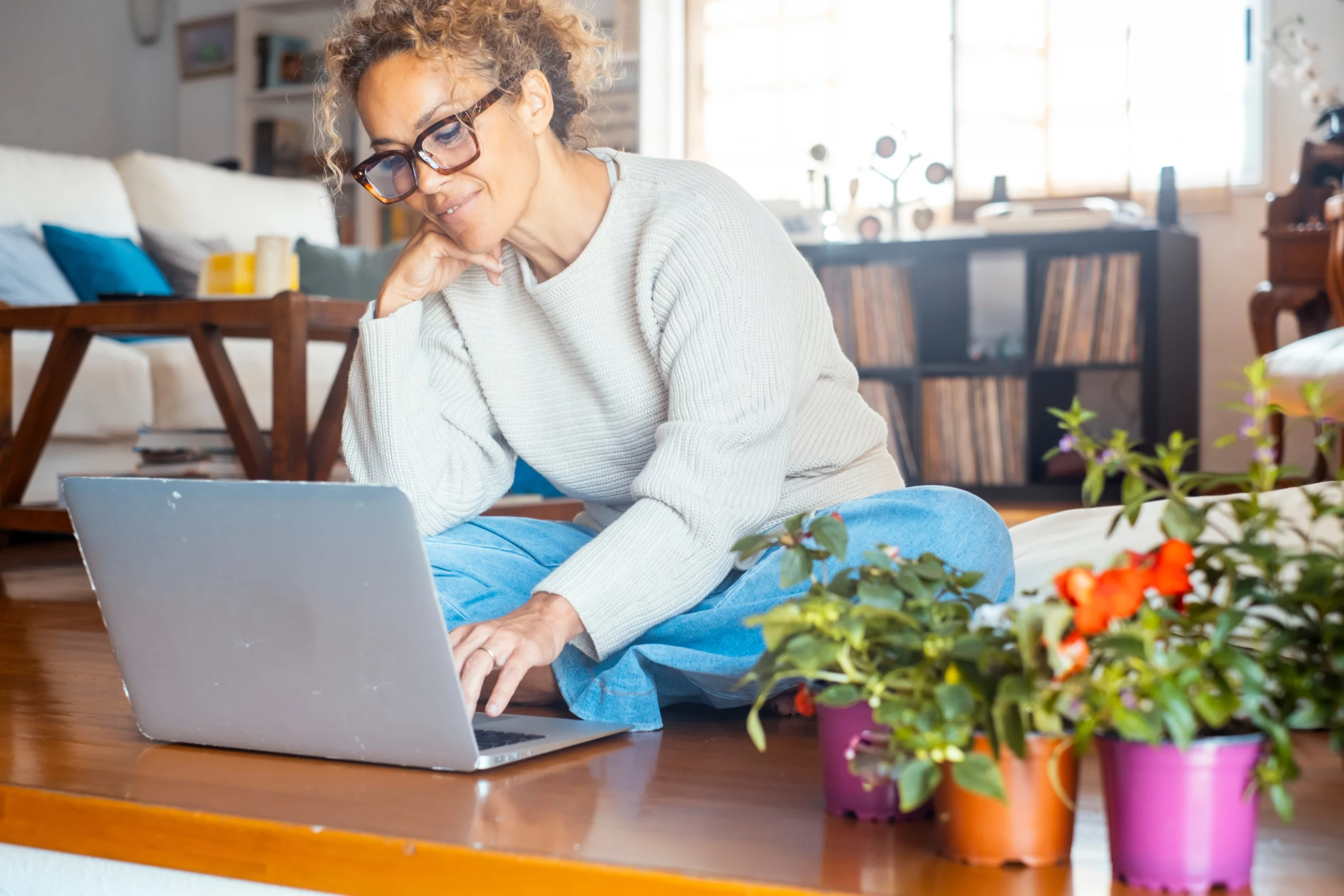 How to Apply for a Personal Loan; woman sits on floor with laptop | Oceania Finance